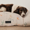 Water-resistant and washable dog bed in rainbow design