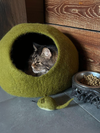Eco-friendly wool pet bed with pebble-inspired shape